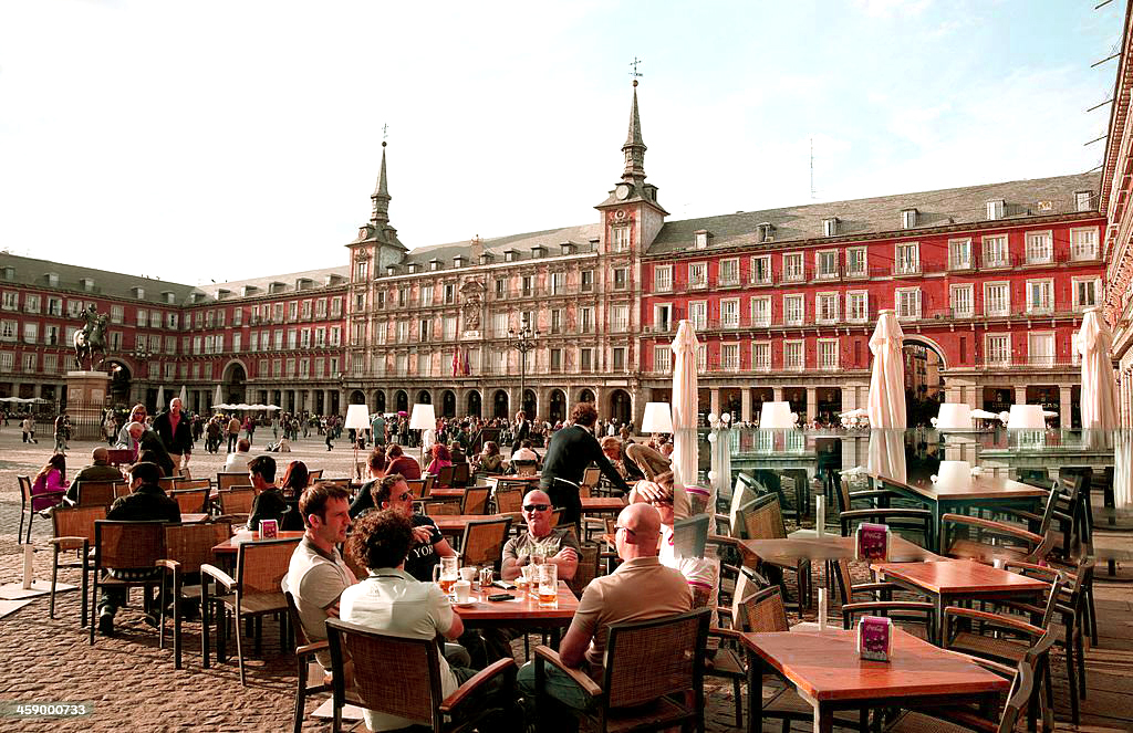 "Madrid, Spain - March 16, 2012: People are eating at the restaurants in the Plaza Mayor of Madrid, one of the main landmarks in the city."